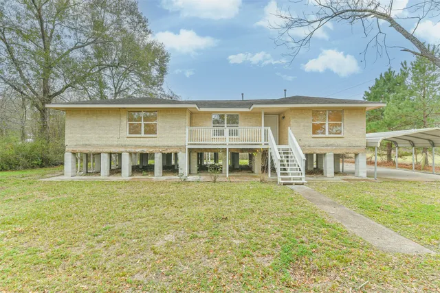 a front view of a house with a garden