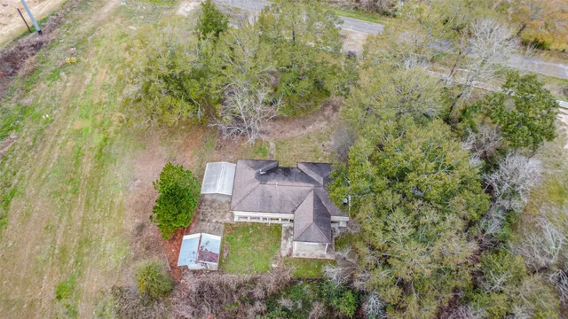 an aerial view of a house with a yard