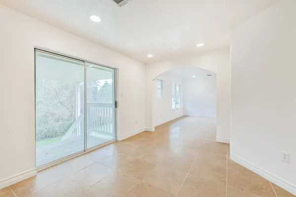 a view of an empty room with glass door