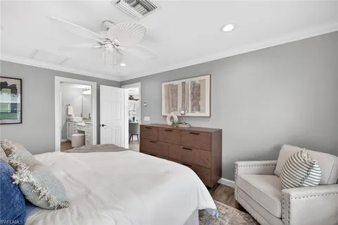 a bedroom with a bed and glass window