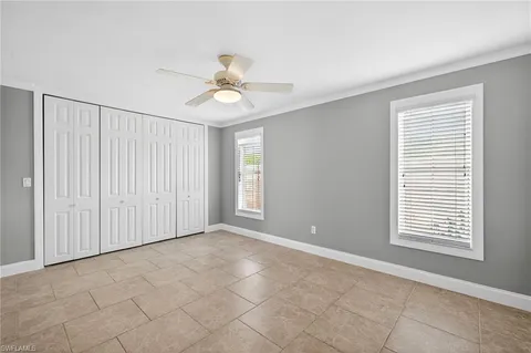 a view of an empty room with a ceiling fan