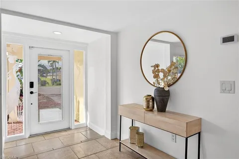 a bathroom with a granite countertop sink a toilet a mirror and vanity