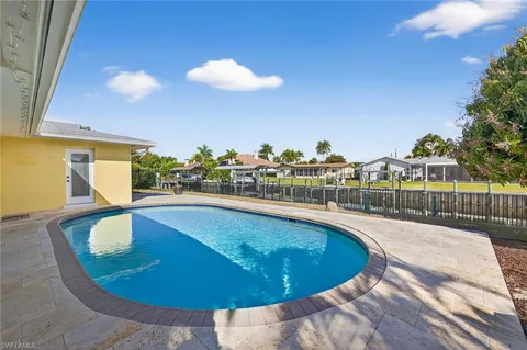 a view of a swimming pool with a lounge chairs