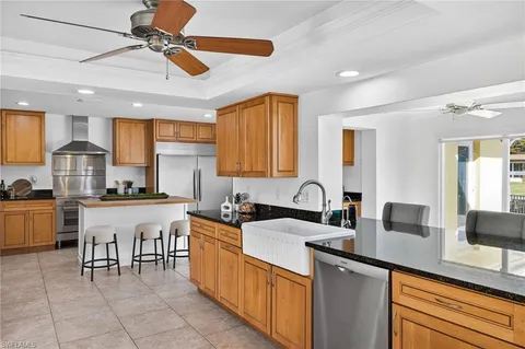 a kitchen with granite countertop a stove top oven and cabinets