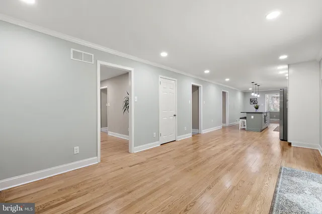 a view of a hallway with wooden floor