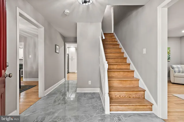 a view of a hallway with wooden floor and entryway