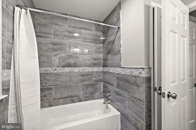 a bathroom with a shower and a bath tub