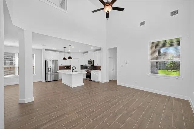 a view of a kitchen with furniture and wooden floor