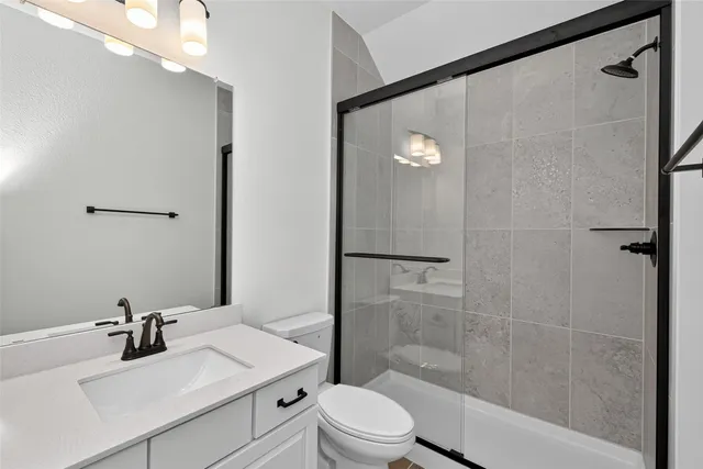 a bathroom with a sink toilet a mirror and shower