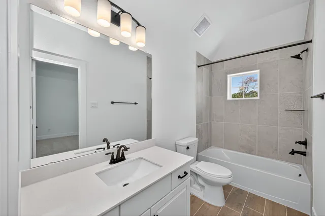 a bathroom with a sink mirror toilet and bathtub