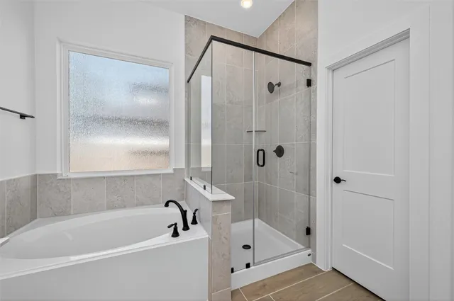 a bathroom with a bathtub and a shower