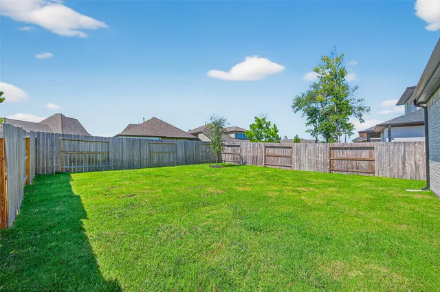 a view of a backyard with a garden and deck