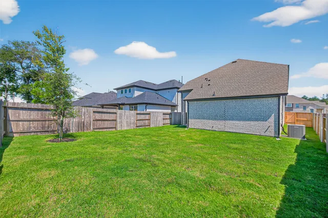 a front view of a house with a garden and yard