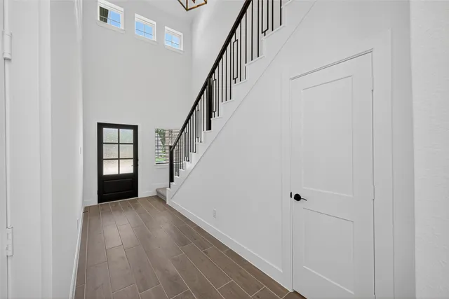 a view of a hallway with wooden floor and entryway