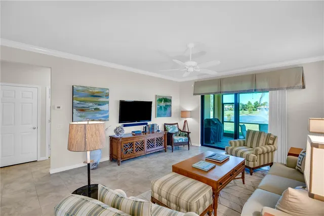 a living room with furniture kitchen view and a window