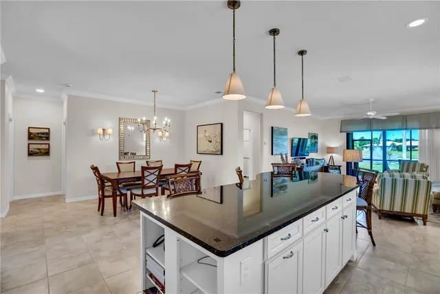 a kitchen with granite countertop white cabinets and stainless steel appliances