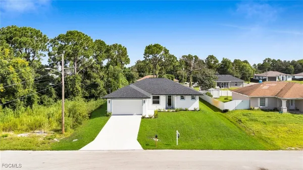 a view of house with garden space and trees