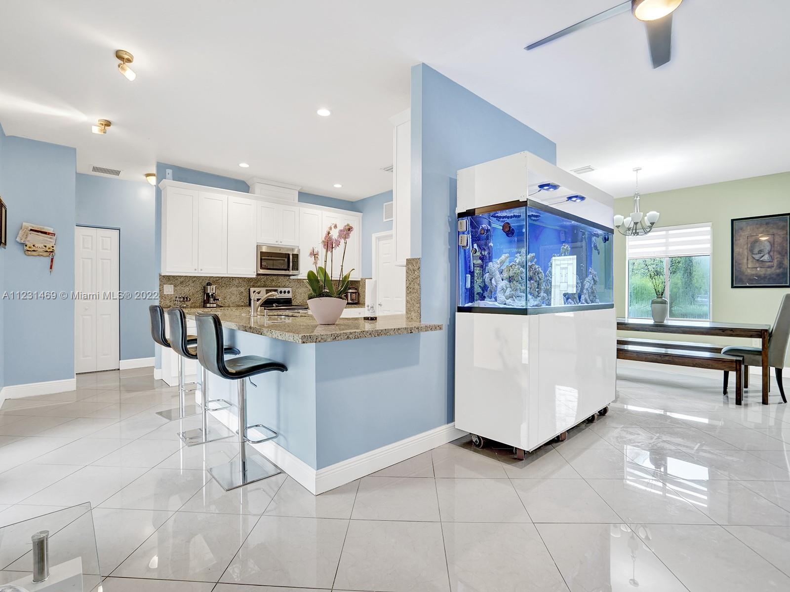 17335 Southwest 298th Street Homestead, FL 33030 - Photo 11 of 32 a living room with furniture and kitchen view