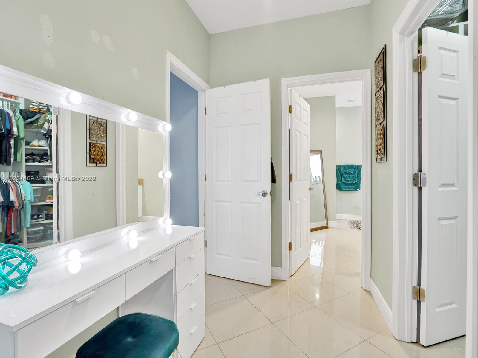 17335 Southwest 298th Street Homestead, FL 33030 - Photo 20 of 32 a spacious bathroom with a granite countertop sink a mirror and a shower