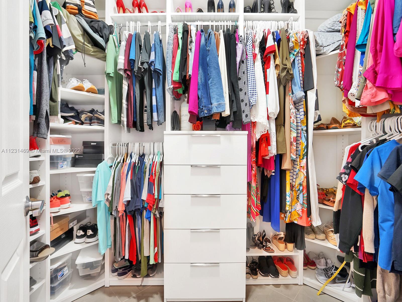 17335 Southwest 298th Street Homestead, FL 33030 - Photo 21 of 32 a view of walk in closet with clothes and shoes