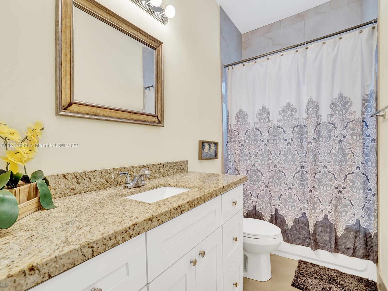 17335 Southwest 298th Street Homestead, FL 33030 - Photo 26 of 32 a bathroom with a granite countertop sink and a mirror