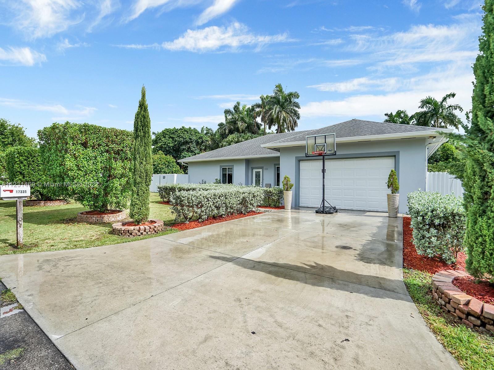 17335 Southwest 298th Street Homestead, FL 33030 - Photo 31 of 32 a view of a house with backyard and trees