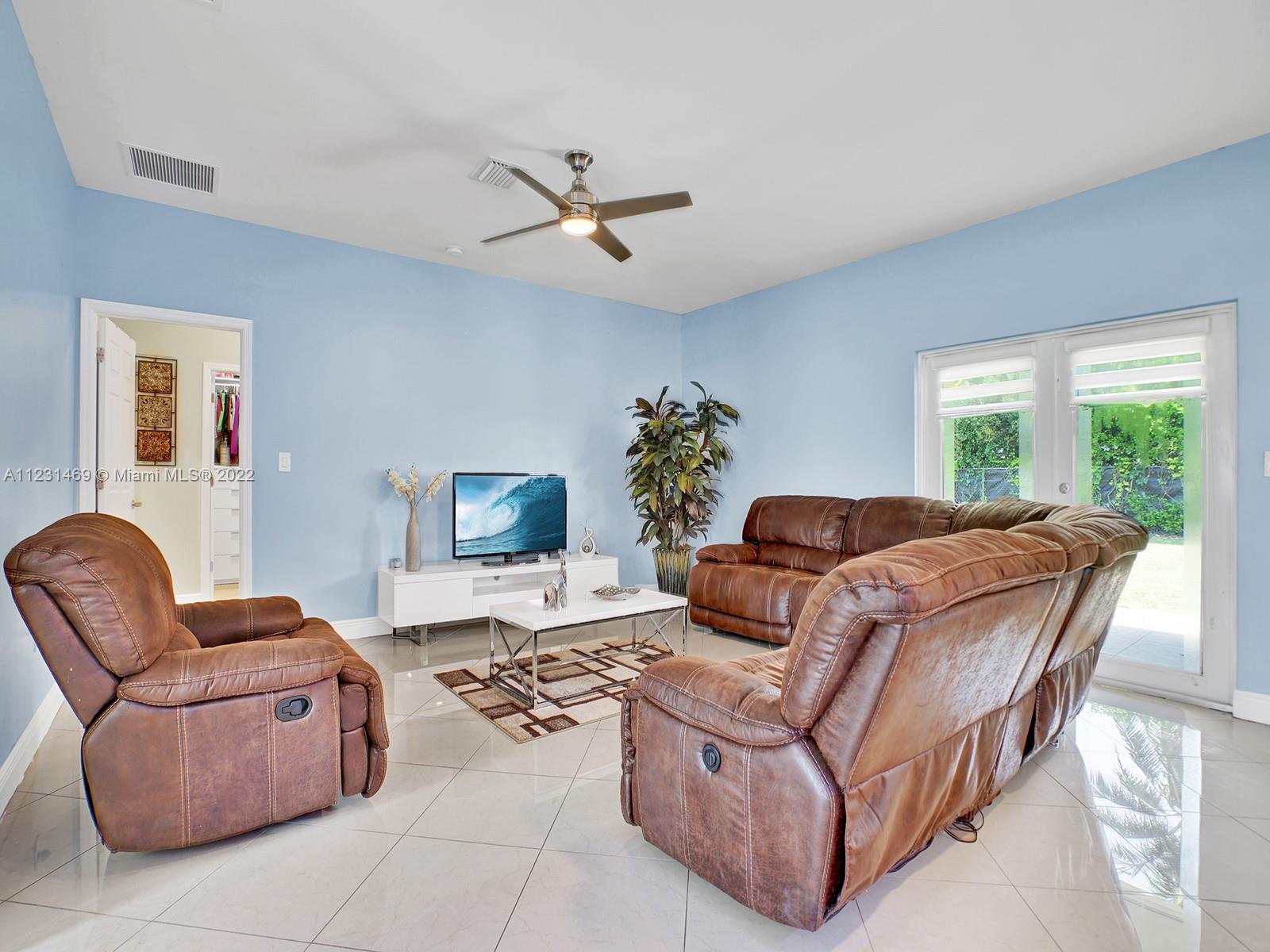 17335 Southwest 298th Street Homestead, FL 33030 - Photo 9 of 32 a living room with furniture flowerpot and a window