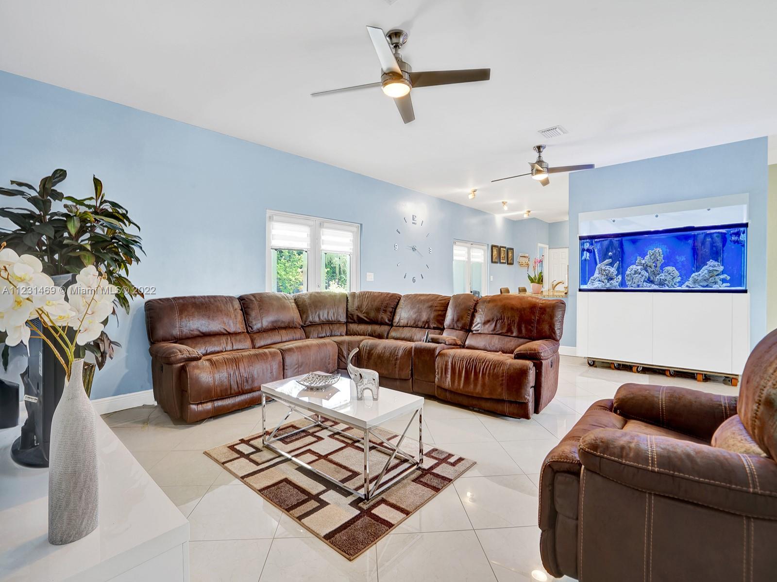 17335 Southwest 298th Street Homestead, FL 33030 - Photo 10 of 32 a living room with furniture a window and a chandelier