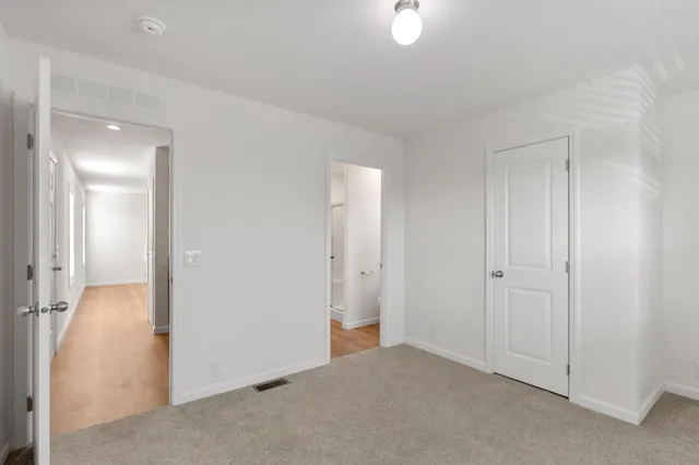 a view of a livingroom with a walk in closet and wooden floor