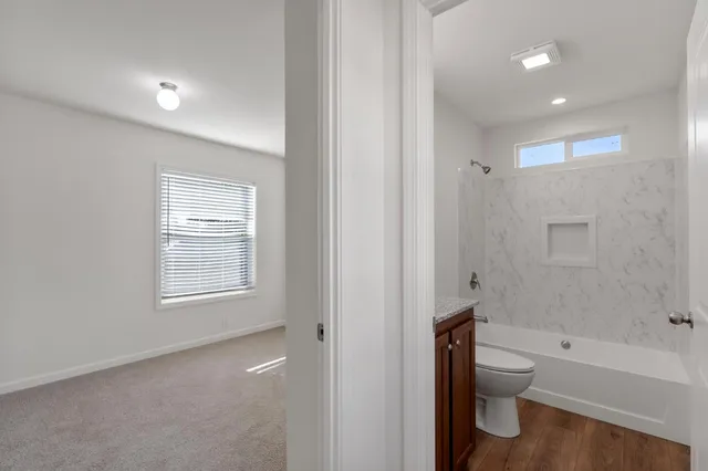 a bathroom with a toilet a sink and bathtub
