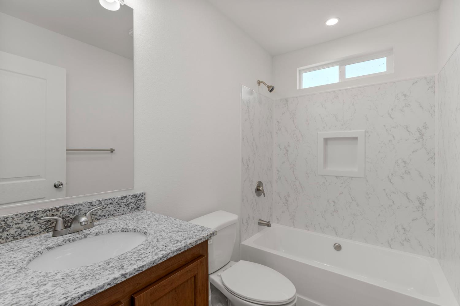 3707 Farmington Road, Unit 7 Stockton, CA 95215 - Photo 16 of 20 a bathroom with a granite countertop sink a toilet and bathtub
