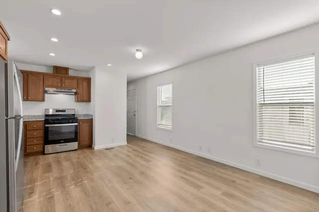 a kitchen with stainless steel appliances a refrigerator and a stove top oven