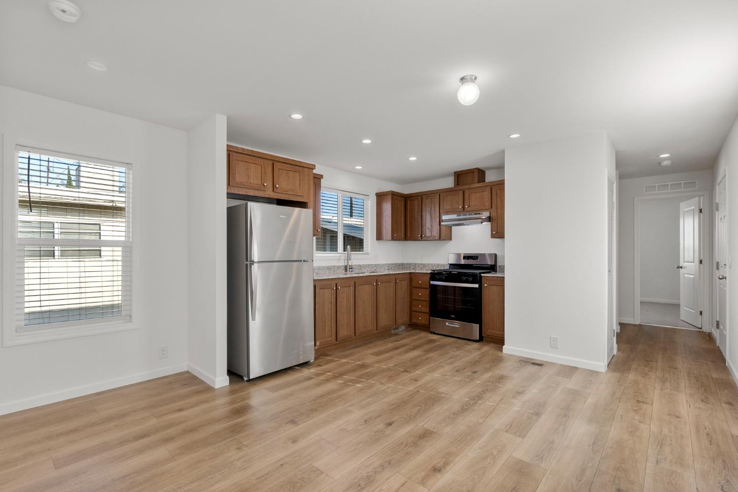 3707 Farmington Road, Unit 7 Stockton, CA 95215 - Photo 6 of 20 a kitchen with a refrigerator and a stove top oven
