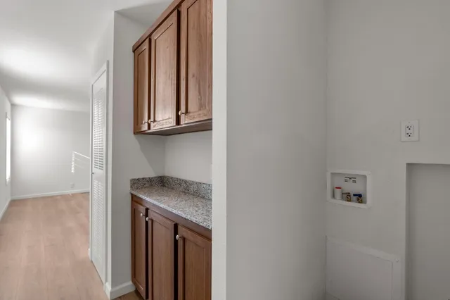 a view of a kitchen with granite countertop cabinets and a wooden floor