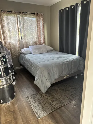a bedroom with a bed and a dresser