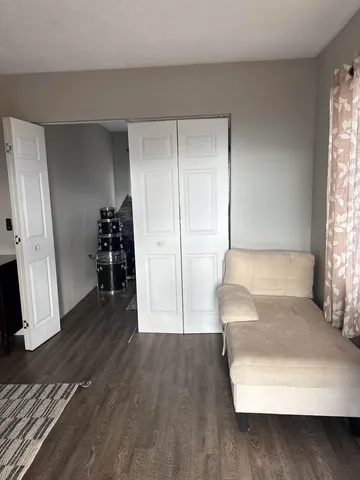 a view of a livingroom with wooden floor and a couch