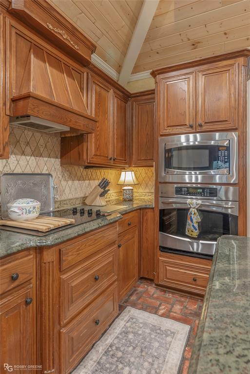 400 Crouch Road Benton, LA 71006 - Photo 19 of 40 a kitchen with granite countertop wooden cabinets and stainless steel appliances