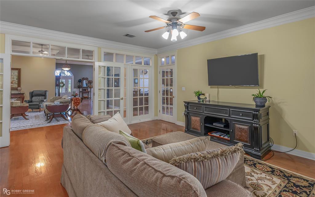400 Crouch Road Benton, LA 71006 - Photo 26 of 40 a living room with furniture a flat screen tv and a fireplace