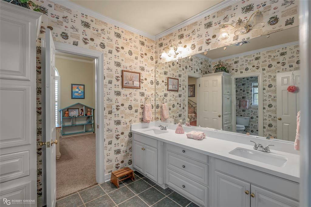 400 Crouch Road Benton, LA 71006 - Photo 32 of 40 a bathroom with a double vanity sink mirror and shower