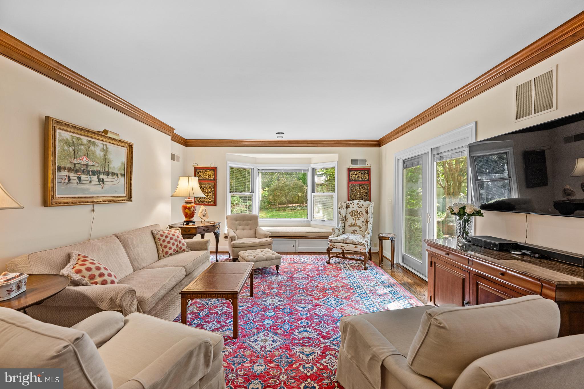 5511 Grove Street Chevy Chase, MD 20815 - Photo 11 of 33 a living room with furniture floor to ceiling window and a flat screen tv