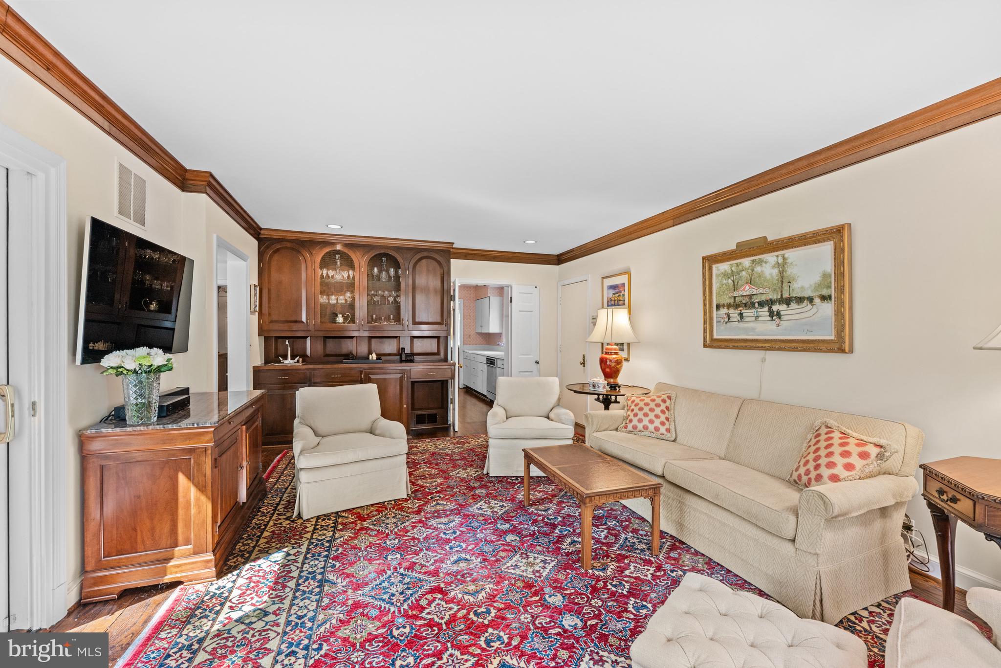 5511 Grove Street Chevy Chase, MD 20815 - Photo 12 of 33 a living room with furniture a rug and a flat screen tv
