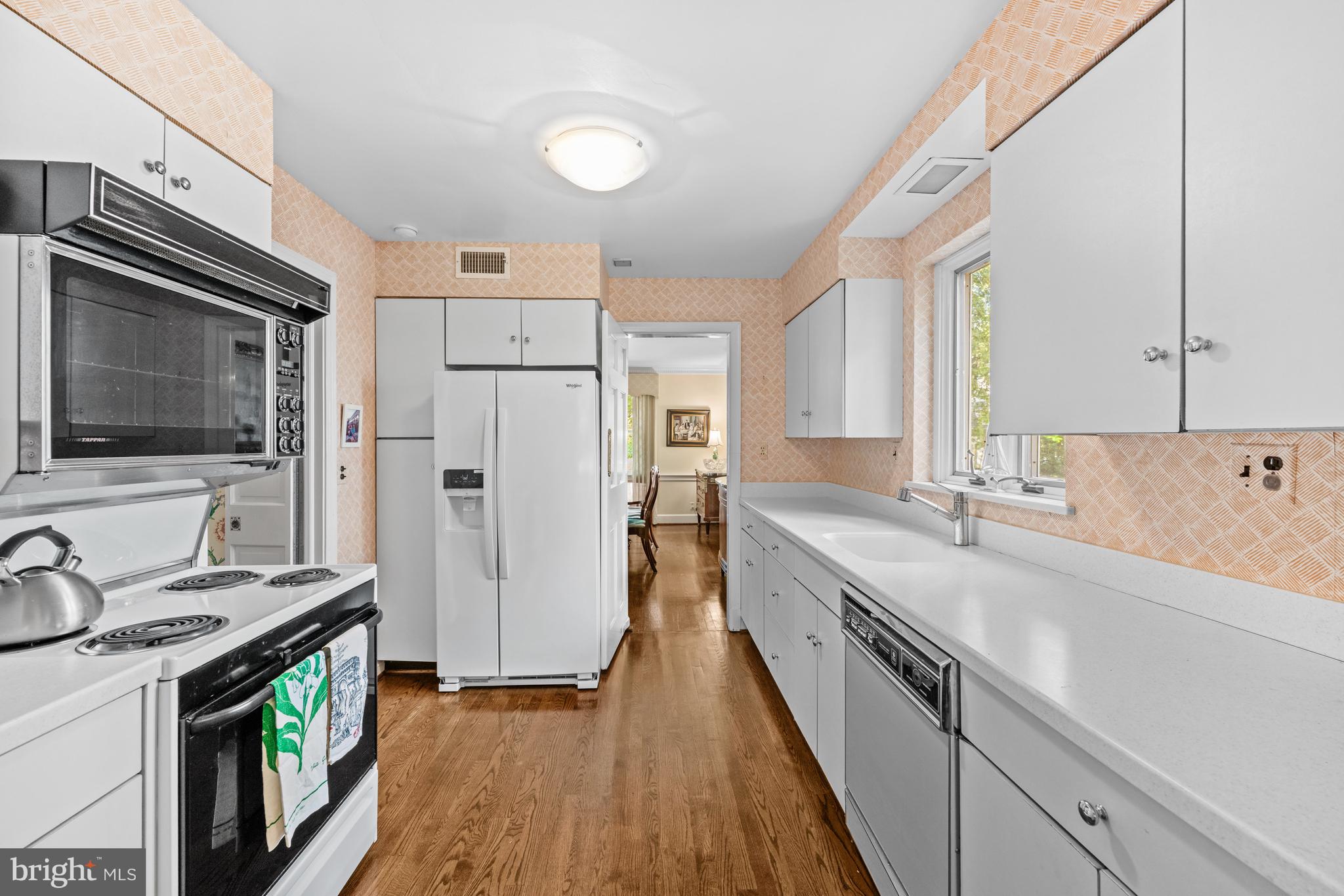 5511 Grove Street Chevy Chase, MD 20815 - Photo 13 of 33 a kitchen with stainless steel appliances granite countertop a sink stove and refrigerator