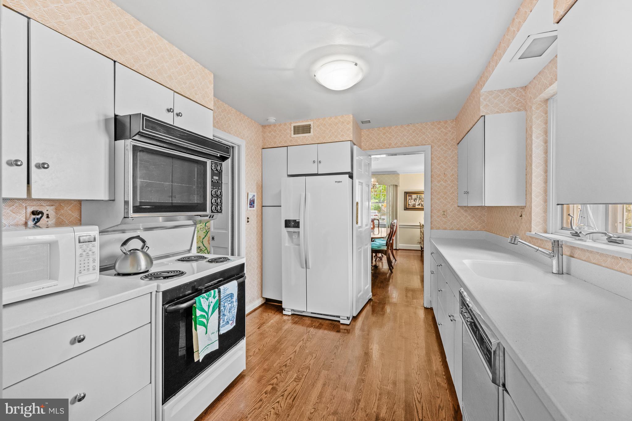 5511 Grove Street Chevy Chase, MD 20815 - Photo 14 of 33 a kitchen with granite countertop a sink stove and refrigerator