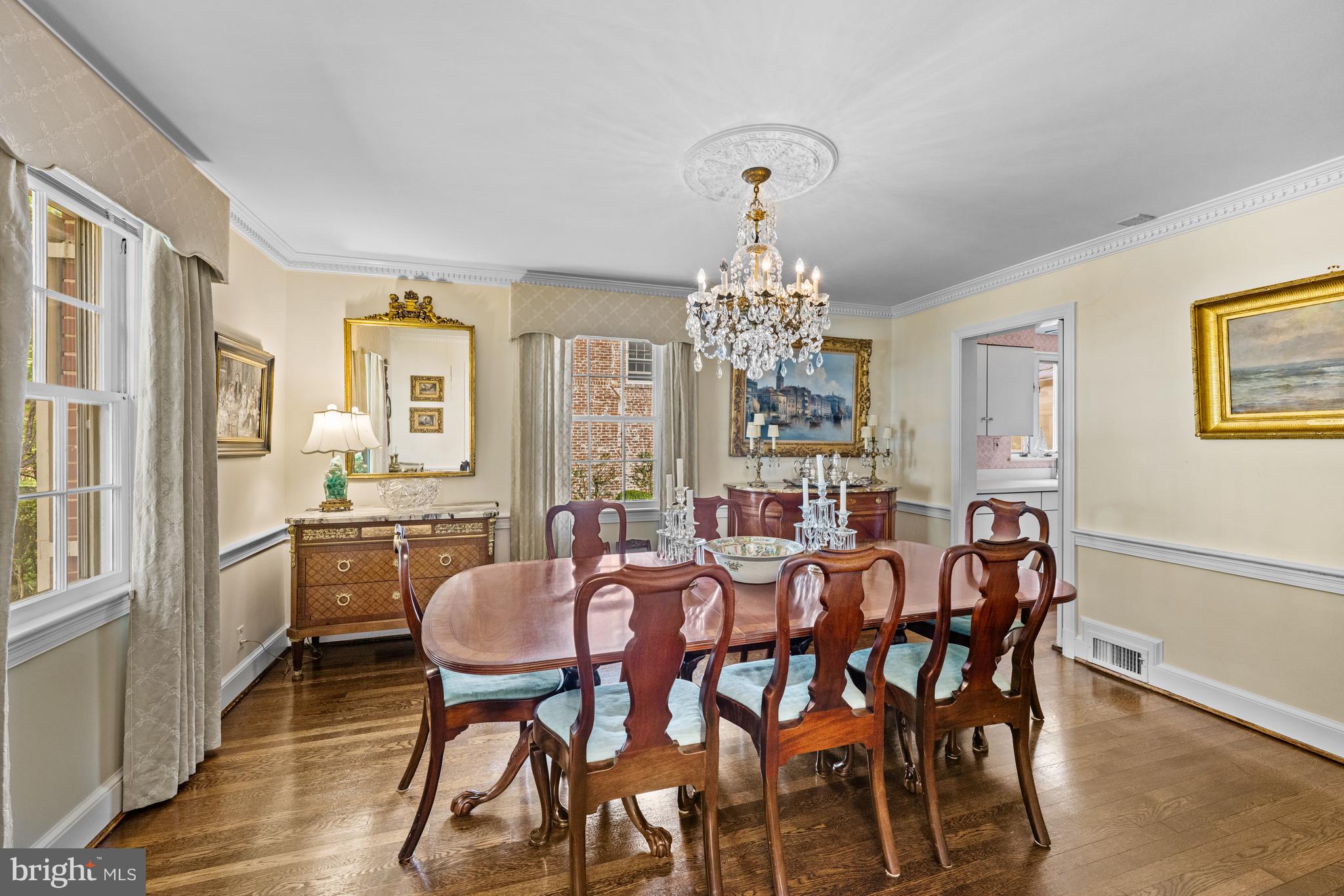 5511 Grove Street Chevy Chase, MD 20815 - Photo 15 of 33 a view of a dining room with furniture a chandelier and wooden floor
