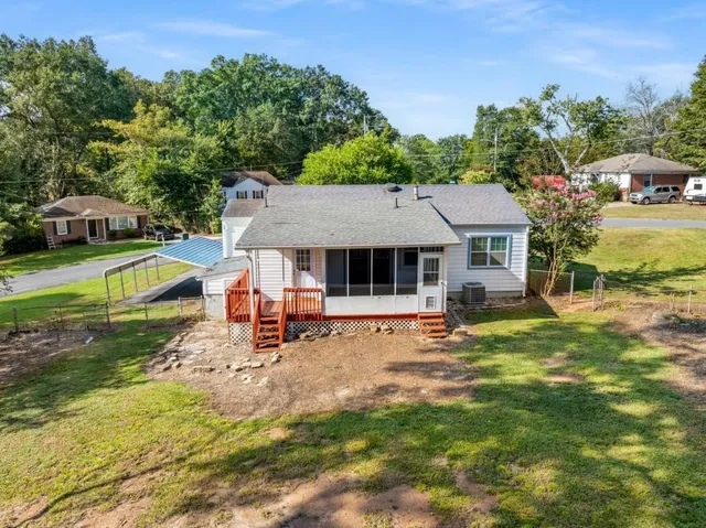 an aerial view of a house with swimming pool and garden
