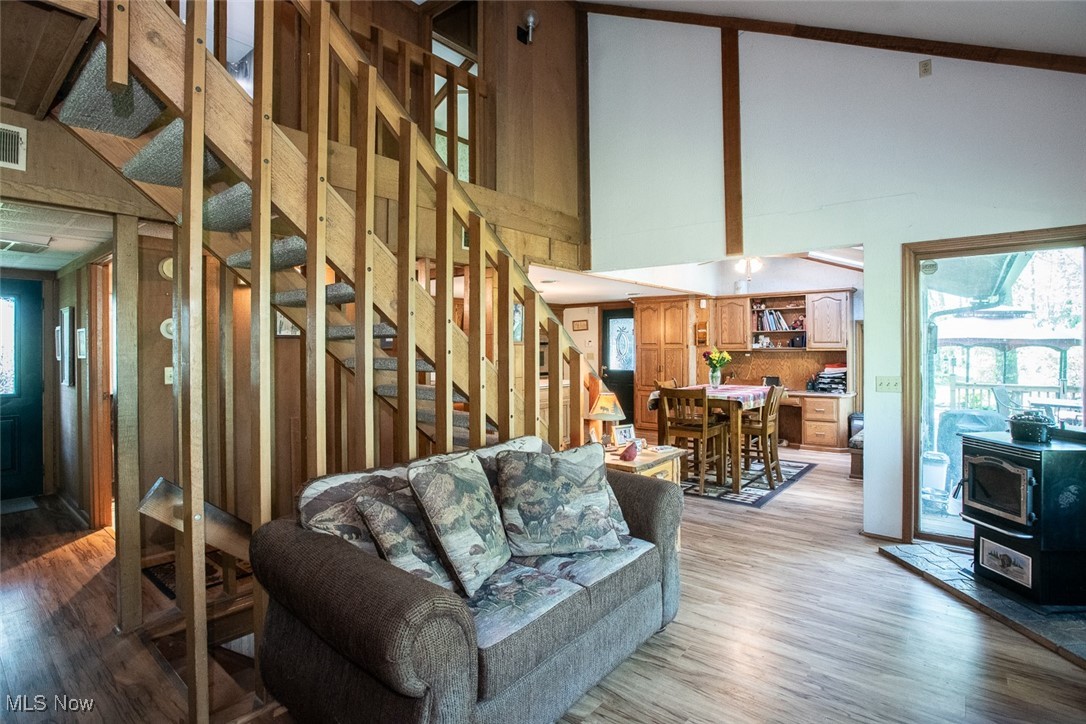41180 Butternut Ridge Road Elyria, OH 44035 - Photo 18 of 50 Living area with light wood-style floors, a towering ceiling, and stairs