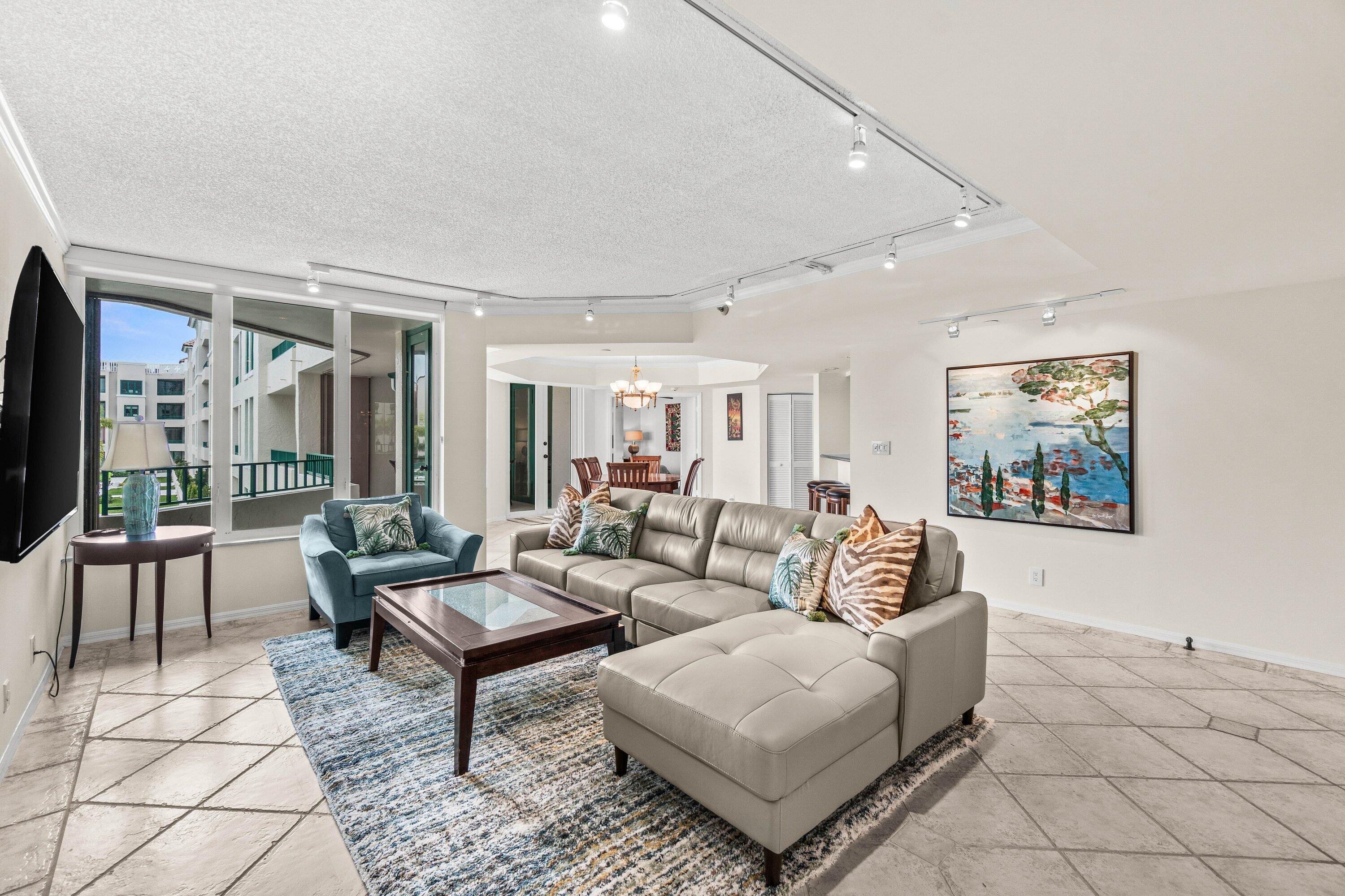 100 Southeast 5th Avenue, Unit 311 Boca Raton, FL 33432 - Photo 2 of 57 a living room with furniture and a flat screen tv