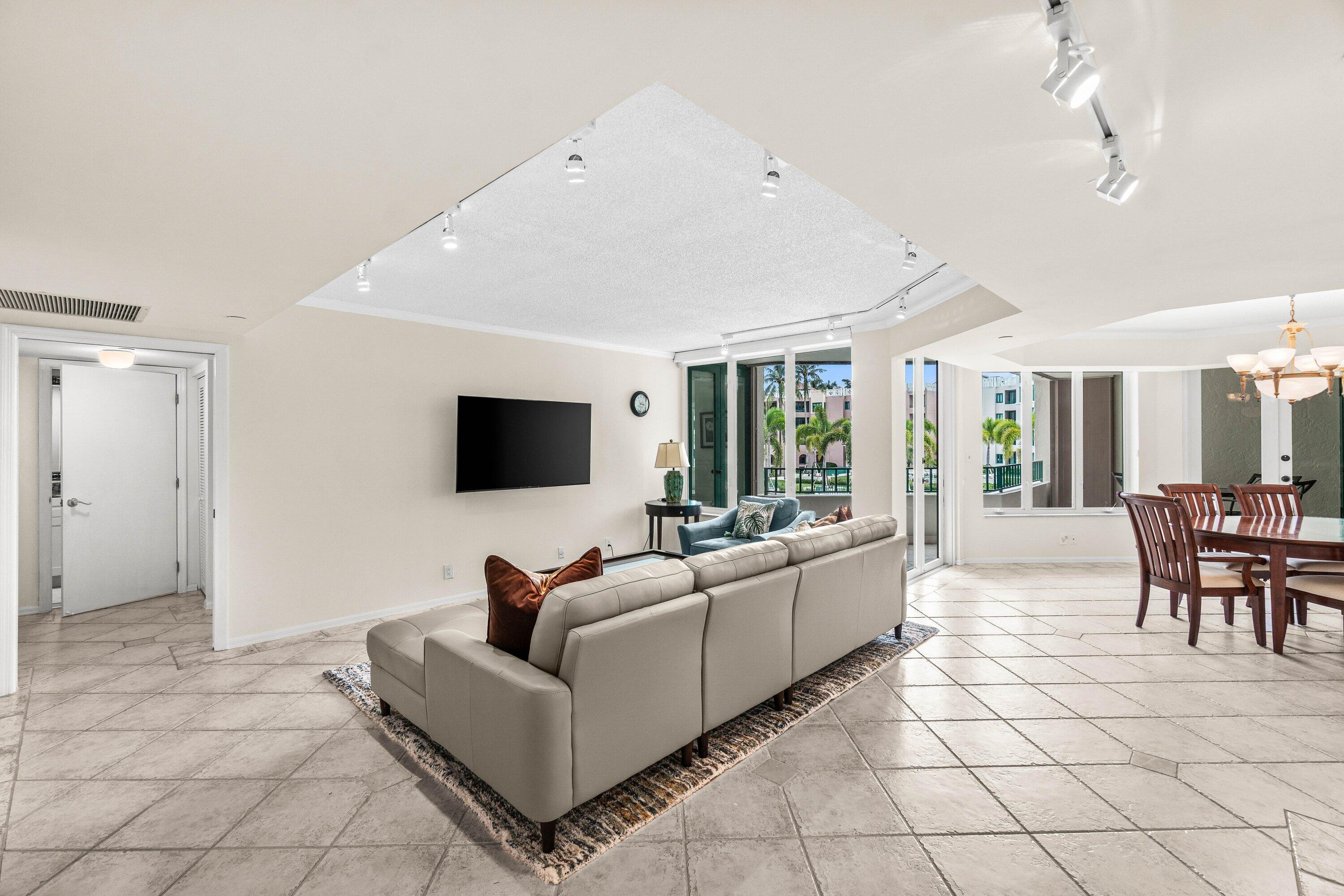 100 Southeast 5th Avenue, Unit 311 Boca Raton, FL 33432 - Photo 4 of 57 a living room with furniture and a flat screen tv