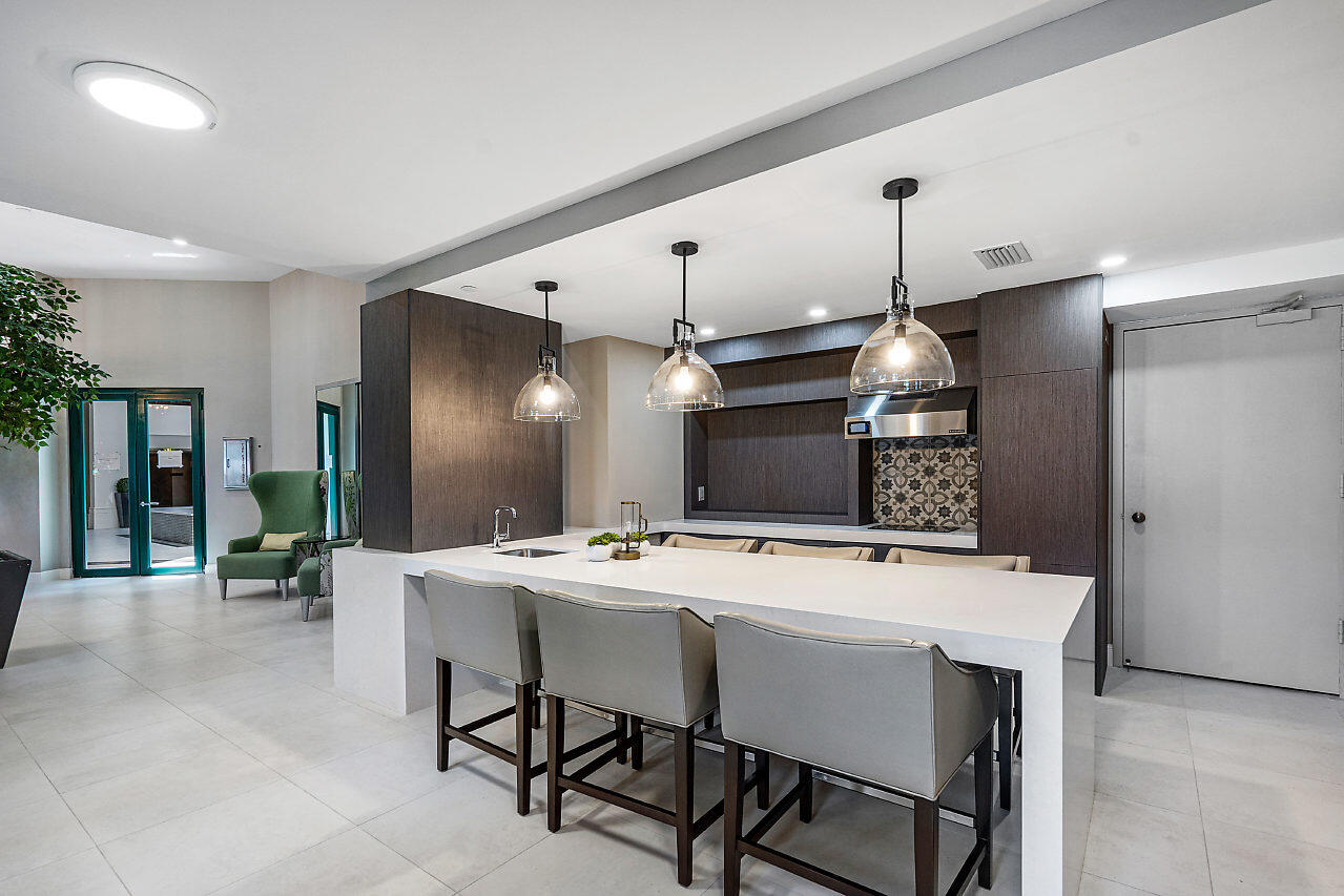 100 Southeast 5th Avenue, Unit 311 Boca Raton, FL 33432 - Photo 47 of 57 a kitchen with a table and chairs
