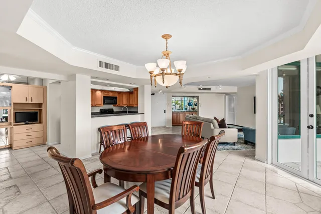 a dining room with furniture a livingroom and chandelier